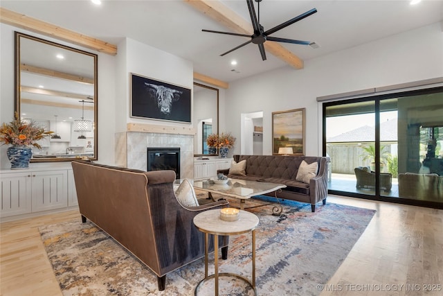 6038 E 119th Pl, Tulsa, OK 74137 - living room featuring beamed ceiling, light wood-style flooring, a premium fireplace, a ceiling fan, and recessed lighting