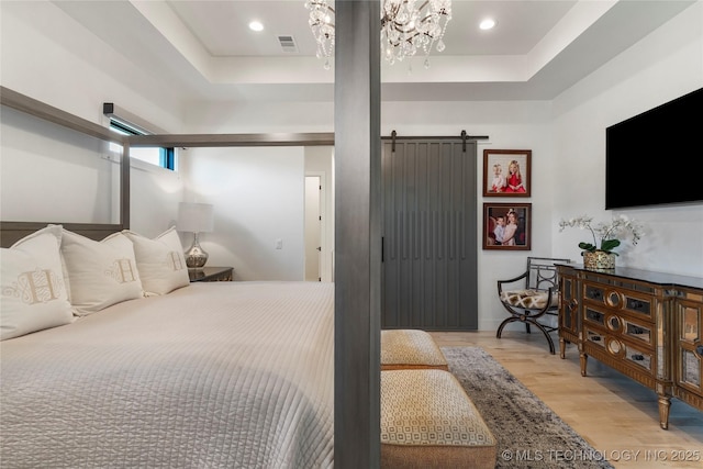 6038 E 119th Pl, Tulsa, OK 74137 - bedroom with a raised ceiling, light wood finished floors, a barn door, a chandelier, and recessed lighting