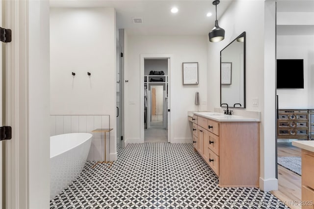 6038 E 119th Pl, Tulsa, OK 74137 - full bath with vanity, a freestanding tub, and recessed lighting