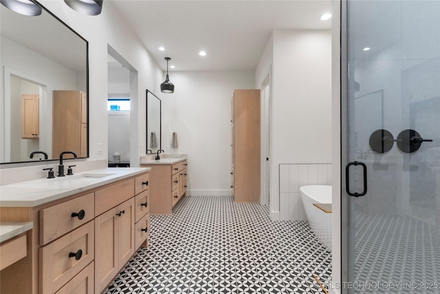 6038 E 119th Pl, Tulsa, OK 74137 - bathroom with two vanities, a shower stall, a soaking tub, and recessed lighting