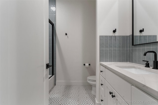 6038 E 119th Pl, Tulsa, OK 74137 - bathroom with vanity, shower / bath combination with glass door, and tasteful backsplash