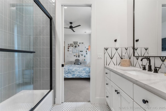 6038 E 119th Pl, Tulsa, OK 74137 - ensuite bathroom featuring ceiling fan, vanity, bath / shower combo with glass door, and decorative backsplash