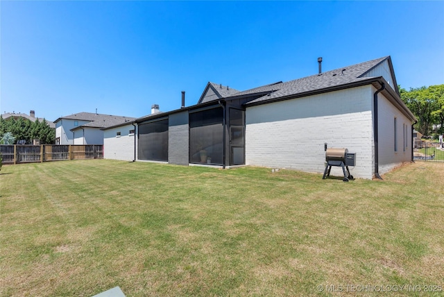 6038 E 119th Pl, Tulsa, OK 74137 - back of property with a fenced backyard and a sunroom