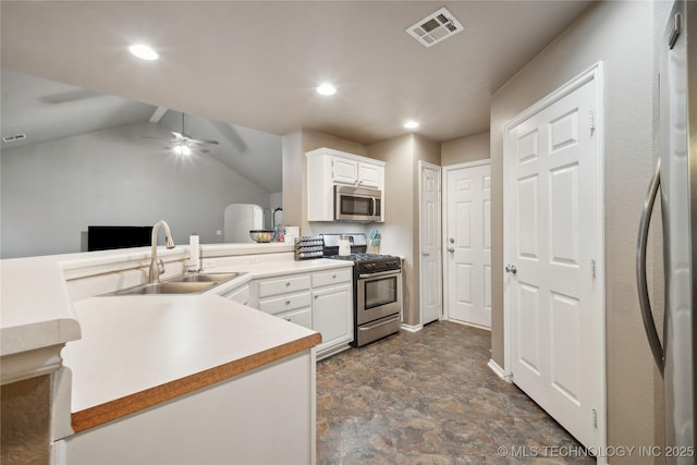 1905 Walnut Hill Ln, Claremore, OK 74019 - kitchen with stainless steel appliances, a sink, white cabinetry, stone finish floors, and light countertops