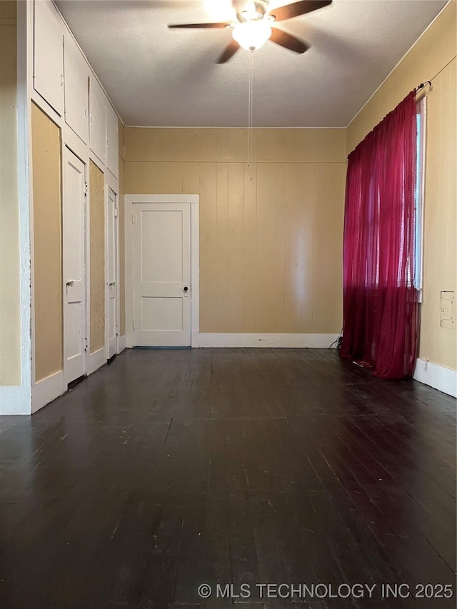 918 W Cedar St, Durant, OK 74701 - empty room featuring ceiling fan, dark wood finished floors, and baseboards
