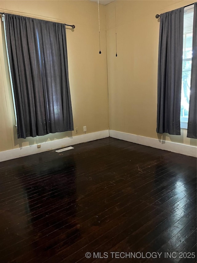 918 W Cedar St, Durant, OK 74701 - empty room featuring dark wood finished floors and baseboards