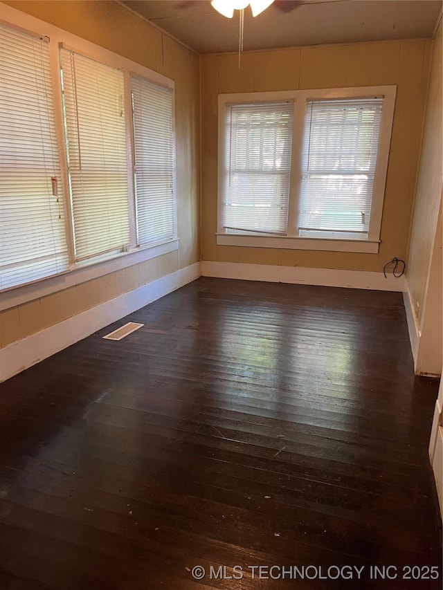 918 W Cedar St, Durant, OK 74701 - empty room featuring dark wood finished floors, baseboards, and ceiling fan