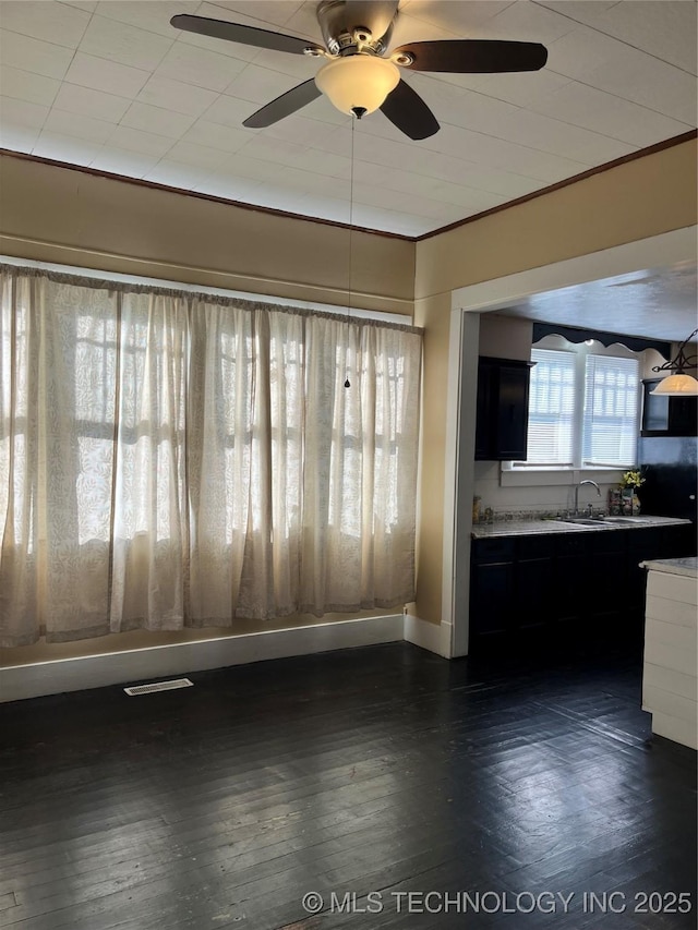 918 W Cedar St, Durant, OK 74701 - unfurnished living room featuring ornamental molding, a ceiling fan, dark wood-style floors, a sink, and baseboards