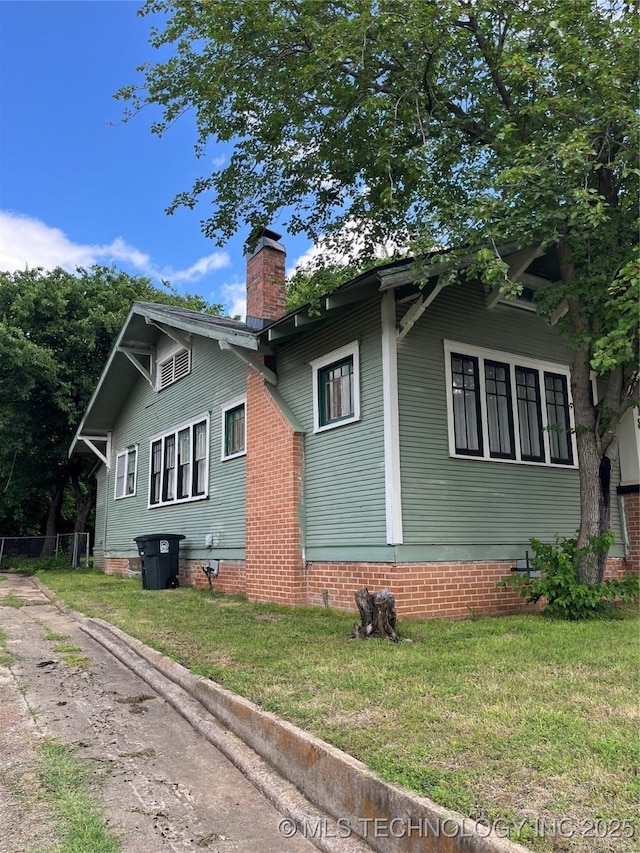 918 W Cedar St, Durant, OK 74701 - view of side of home with a chimney and a lawn