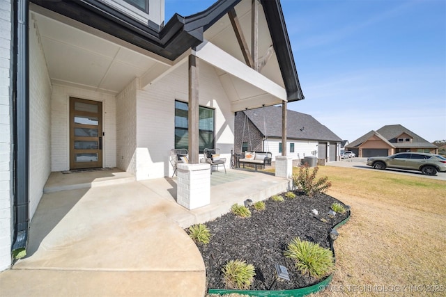property entrance with a yard and brick siding