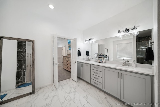 bathroom featuring marble look tiles and double vanity