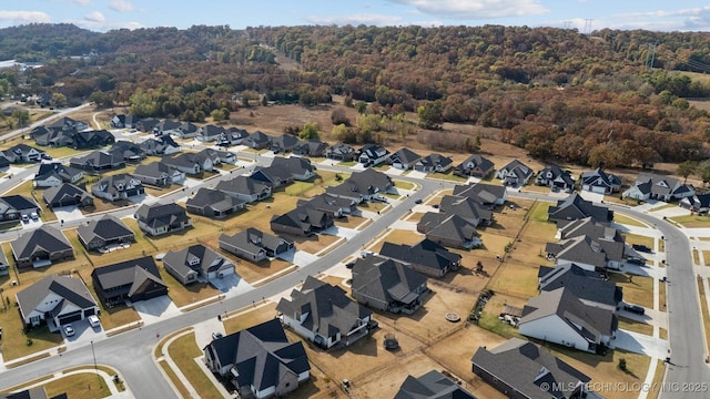 aerial overview of property's location featuring a heavily wooded area and nearby suburban area