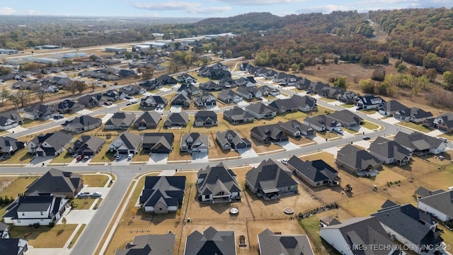 aerial view of property and surrounding area featuring nearby suburban area
