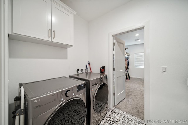 laundry area featuring cabinet space, independent washer and dryer, and light carpet