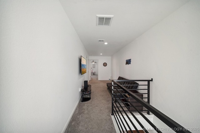 hallway featuring an upstairs landing, carpet flooring, recessed lighting, and baseboards