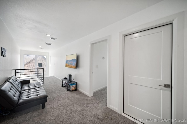 unfurnished living room featuring carpet floors and baseboards