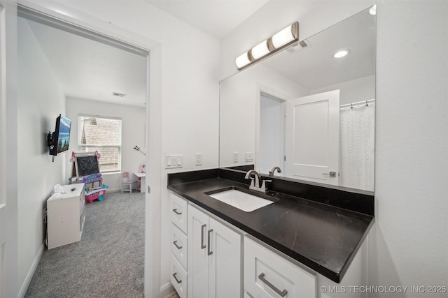 full bath featuring vanity and baseboards