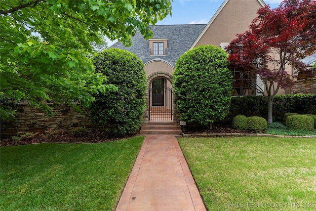 11616 S Hudson Ct, Tulsa, OK 74137 - tudor home featuring a front lawn, roof with shingles, and stucco siding
