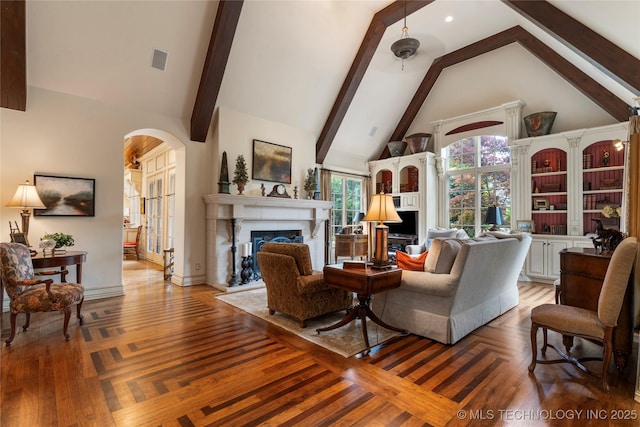 11616 S Hudson Ct, Tulsa, OK 74137 - living room featuring arched walkways, high vaulted ceiling, a fireplace, beamed ceiling, and baseboards