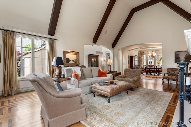 11616 S Hudson Ct, Tulsa, OK 74137 - living area with arched walkways, high vaulted ceiling, a chandelier, healthy amount of natural light, and beam ceiling
