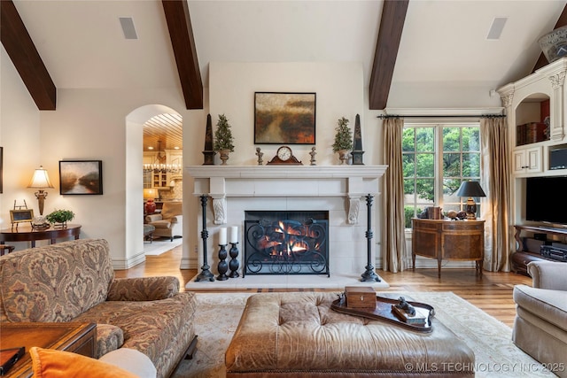 11616 S Hudson Ct, Tulsa, OK 74137 - living room featuring wood finished floors, arched walkways, and a fireplace