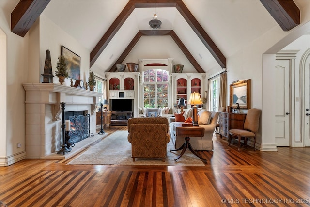 11616 S Hudson Ct, Tulsa, OK 74137 - living area with a warm lit fireplace, wood finished floors, beam ceiling, high vaulted ceiling, and baseboards