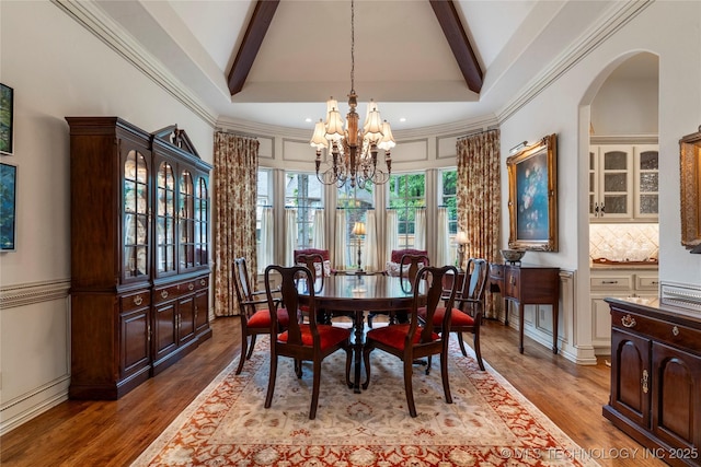 11616 S Hudson Ct, Tulsa, OK 74137 - dining room with a chandelier, beamed ceiling, wood finished floors, and arched walkways