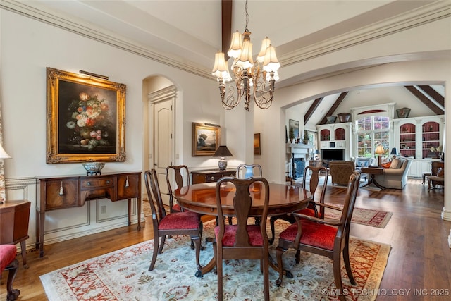11616 S Hudson Ct, Tulsa, OK 74137 - dining room featuring arched walkways, a chandelier, and wood finished floors