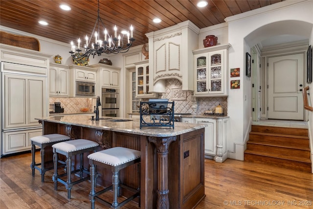 11616 S Hudson Ct, Tulsa, OK 74137 - kitchen featuring arched walkways, stainless steel appliances, decorative backsplash, dark wood-style floors, and recessed lighting