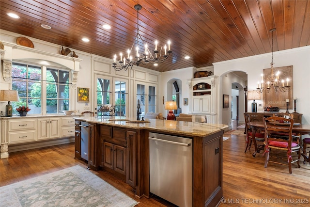 11616 S Hudson Ct, Tulsa, OK 74137 - kitchen featuring arched walkways, a chandelier, stainless steel dishwasher, cream cabinetry, and crown molding