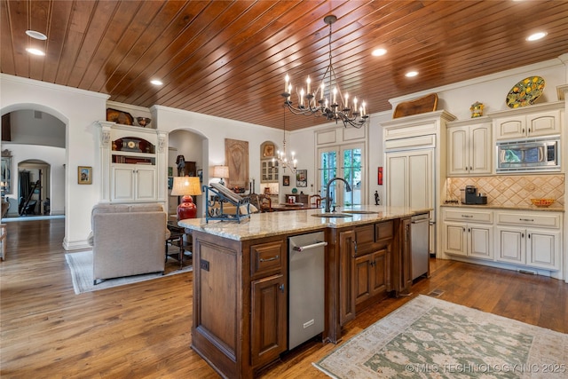 11616 S Hudson Ct, Tulsa, OK 74137 - kitchen with stainless steel appliances, a sink, arched walkways, wood ceiling, and open floor plan