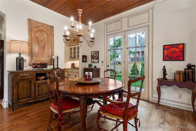 11616 S Hudson Ct, Tulsa, OK 74137 - dining room featuring wood ceiling, crown molding, light wood-style flooring, and a chandelier