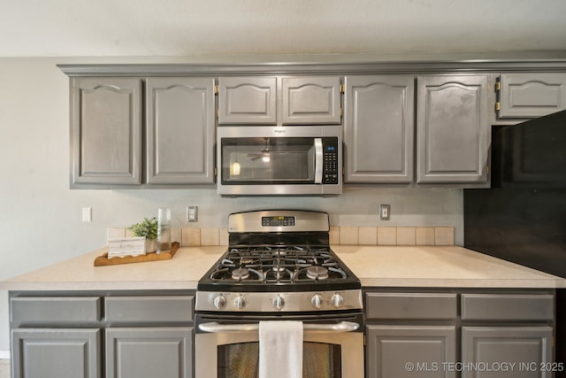 4719 S 194th E Ave, Broken Arrow, OK 74014 - kitchen with stainless steel appliances, gray cabinetry, and light countertops