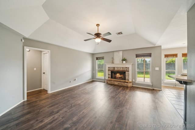 4719 S 194th E Ave, Broken Arrow, OK 74014 - unfurnished living room with vaulted ceiling, a ceiling fan, plenty of natural light, dark wood-style flooring, and a fireplace
