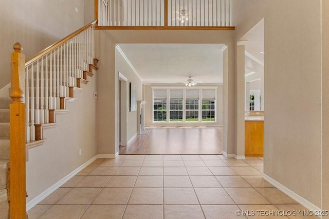 8531 S 70th E Ave, Tulsa, OK 74133 - entrance foyer with ceiling fan, ornamental molding, light tile patterned floors, stairs, and baseboards