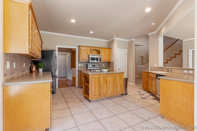 8531 S 70th E Ave, Tulsa, OK 74133 - kitchen with appliances with stainless steel finishes, decorative backsplash, light countertops, ornamental molding, and a sink