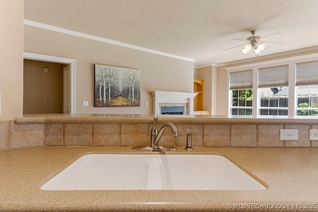 8531 S 70th E Ave, Tulsa, OK 74133 - kitchen featuring crown molding, a sink, a ceiling fan, a fireplace, and open floor plan