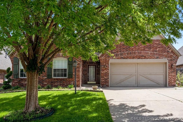 8531 S 70th E Ave, Tulsa, OK 74133 - obstructed view of property with brick siding, concrete driveway, a garage, and a front lawn