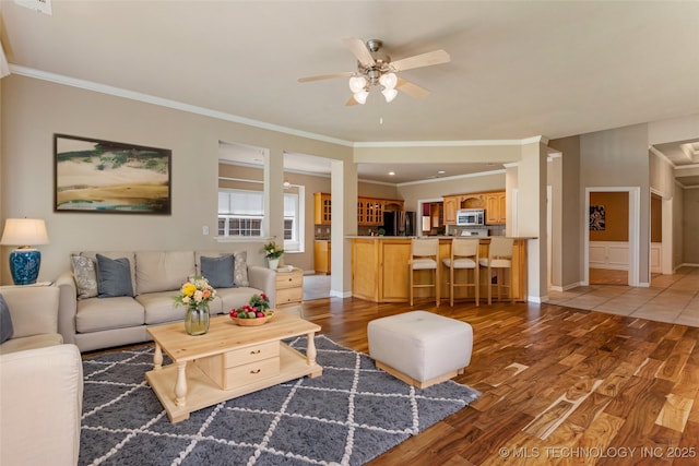 8531 S 70th E Ave, Tulsa, OK 74133 - living room with light wood finished floors, ceiling fan, crown molding, and baseboards