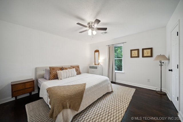 bedroom featuring dark wood-style flooring, baseboards, and ceiling fan