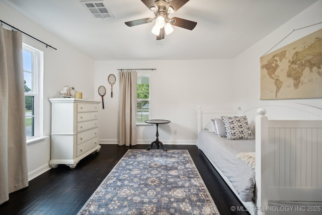 bedroom with baseboards, dark wood-style floors, and a ceiling fan
