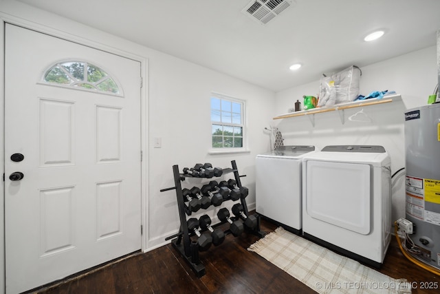 laundry area with water heater, washer and clothes dryer, wood finished floors, baseboards, and recessed lighting