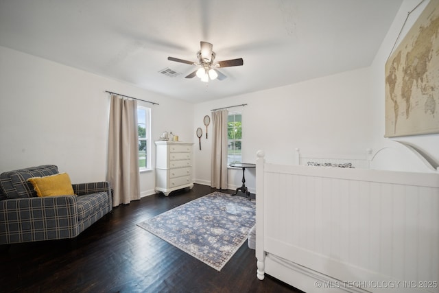 bedroom with wood finished floors, a ceiling fan, and baseboards