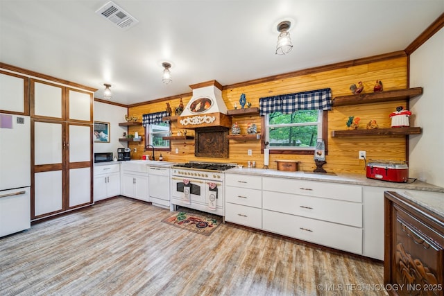 6019 E 620th Rd W, Locust Grove, OK 74352 - kitchen with open shelves, white appliances, a sink, premium range hood, and white cabinetry