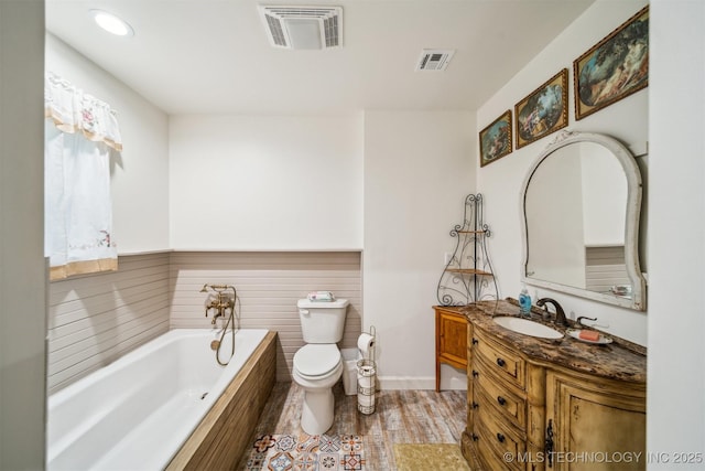 6019 E 620th Rd W, Locust Grove, OK 74352 - bathroom featuring vanity, toilet, a bath, wood finished floors, and baseboards
