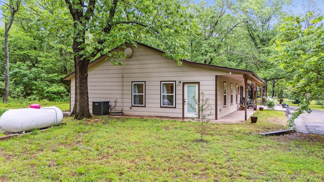 6019 E 620th Rd W, Locust Grove, OK 74352 - view of home's exterior featuring a yard, cooling unit, and a patio