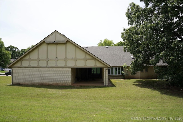 5941 E 87th St, Tulsa, OK 74133 - back of house featuring a yard, roof with shingles, and brick siding