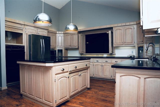 5941 E 87th St, Tulsa, OK 74133 - kitchen with black refrigerator, dark countertops, a sink, dark wood finished floors, and a kitchen island