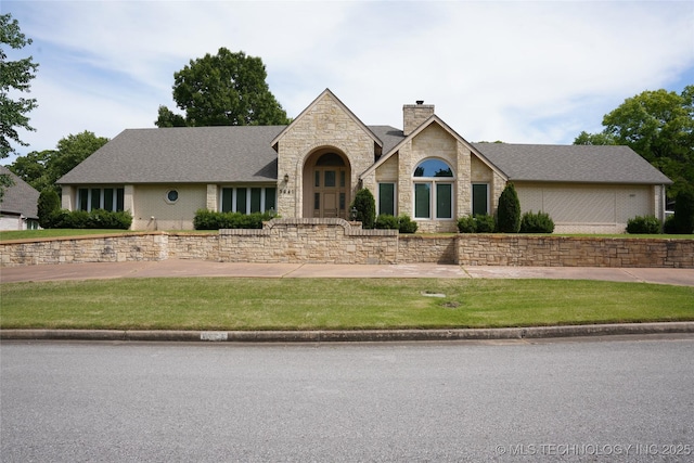 5941 E 87th St, Tulsa, OK 74133 - view of front facade with stone siding, a chimney, and a front lawn