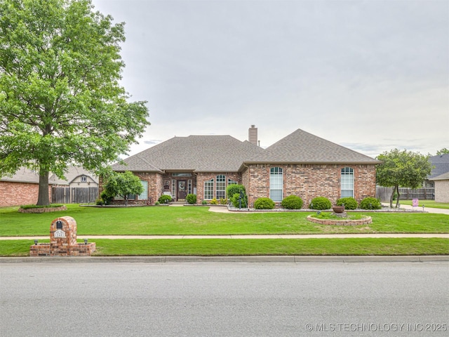 single story home featuring brick siding, a chimney, and roof with shingles